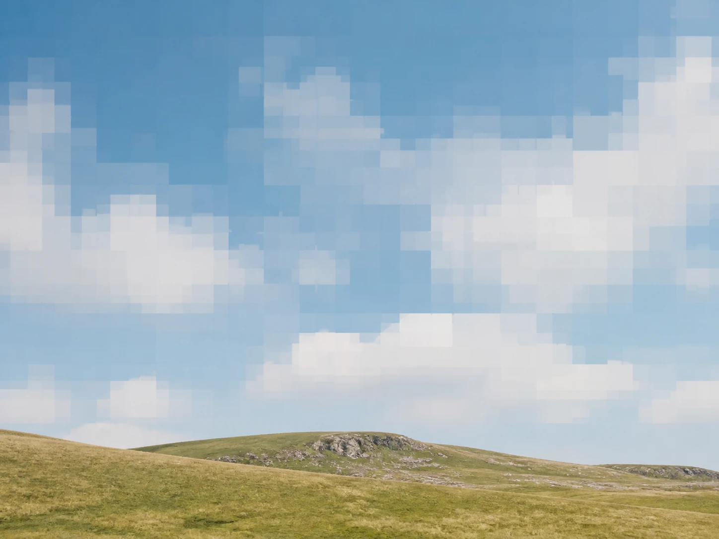 A resaved JPEG photo showing square blocks on a flat sky background